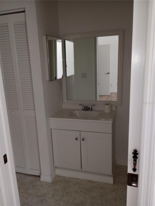 bathroom featuring vanity with extensive cabinet space and tile floors