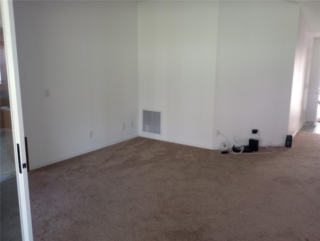 empty room with carpet flooring and visible vents