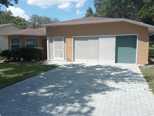 single story home with an outdoor structure and a garage