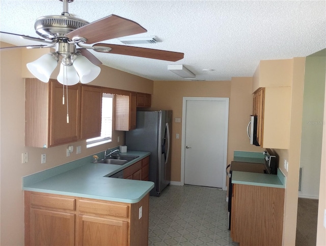 kitchen featuring light tile flooring, kitchen peninsula, ceiling fan, sink, and appliances with stainless steel finishes