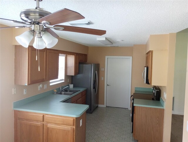 kitchen with visible vents, a sink, stainless steel microwave, light floors, and stove