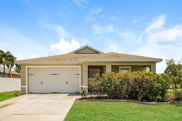 view of front of house featuring a front yard and a garage