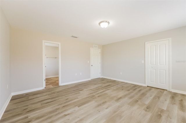 spare room with light hardwood / wood-style floors