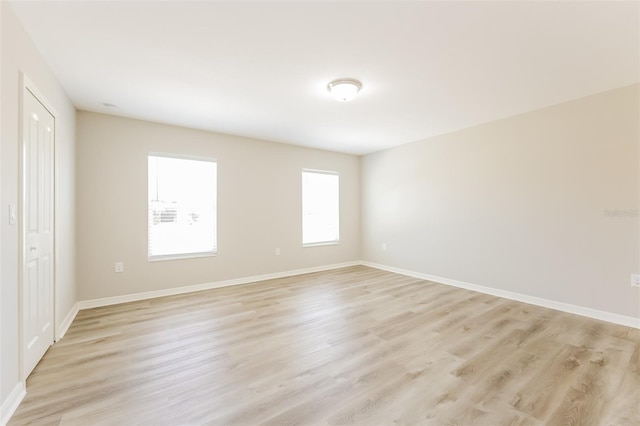 spare room with light hardwood / wood-style flooring