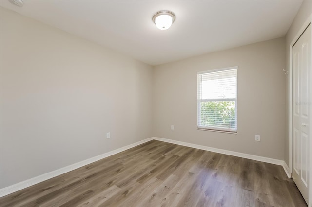 unfurnished room with hardwood / wood-style floors