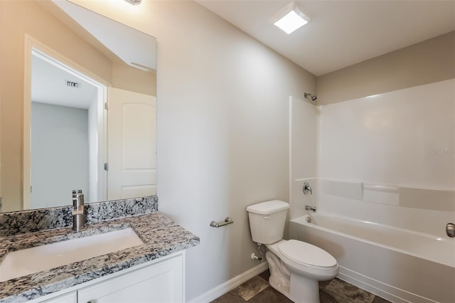 full bathroom featuring washtub / shower combination, vanity, tile floors, and toilet