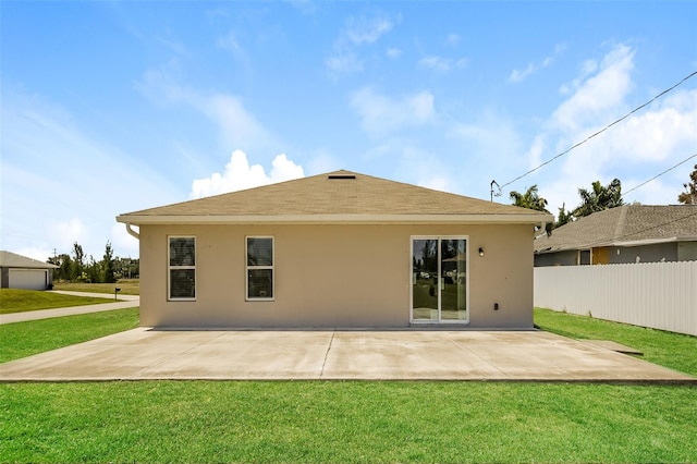 back of property with a lawn and a patio area