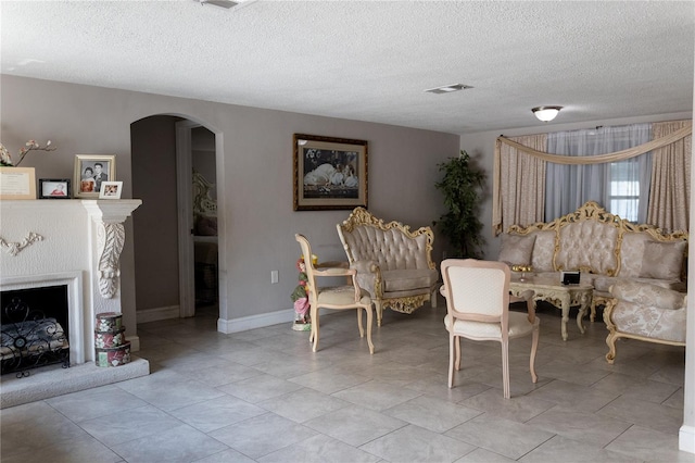 dining space featuring a textured ceiling and light tile patterned floors