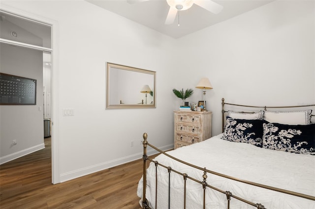 bedroom featuring ceiling fan, wood-type flooring, and vaulted ceiling