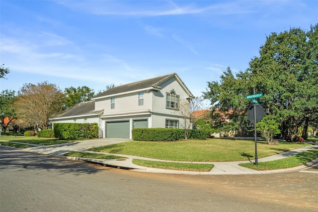 front of property with a front yard and a garage