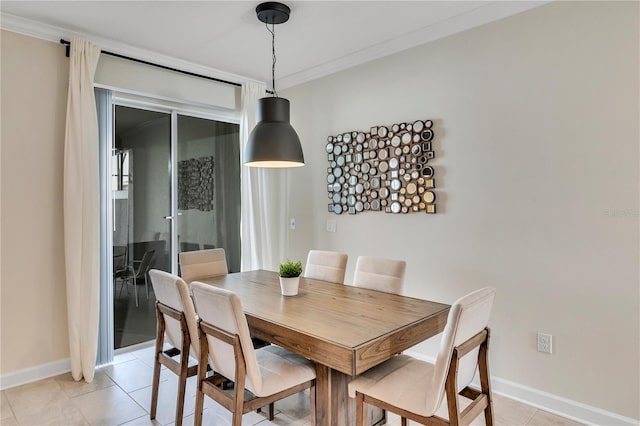 dining area featuring crown molding and light tile floors