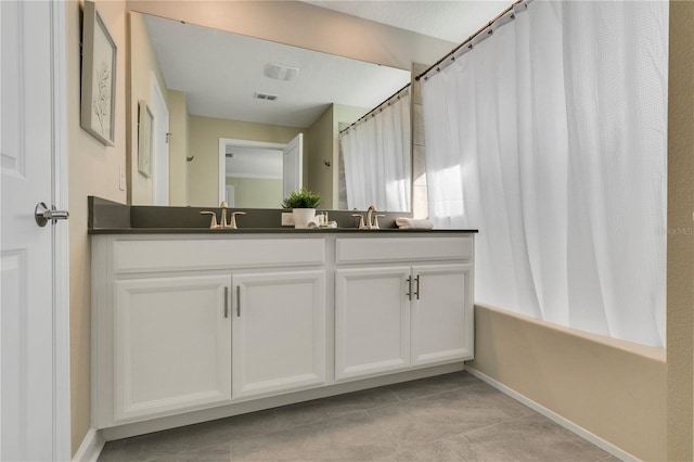 bathroom with tile flooring and vanity