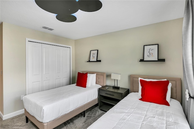 carpeted bedroom with a closet and ceiling fan