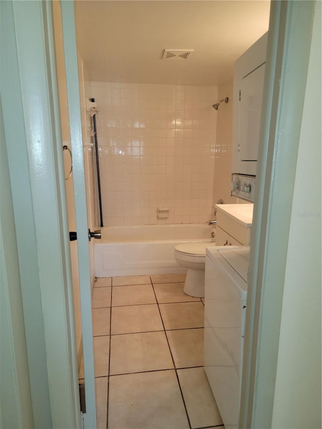 full bathroom featuring tile patterned flooring, vanity, toilet, and tiled shower / bath