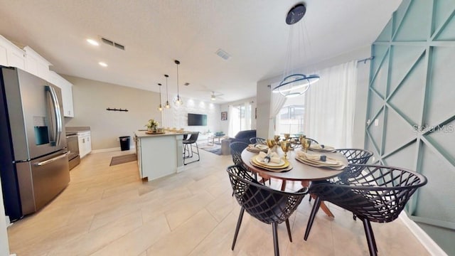 dining area featuring light tile floors