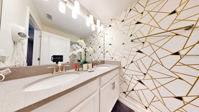 bathroom with vanity with extensive cabinet space and double sink