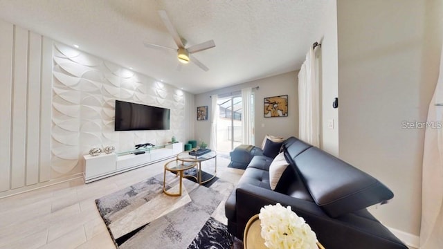 tiled living room with ceiling fan and a textured ceiling