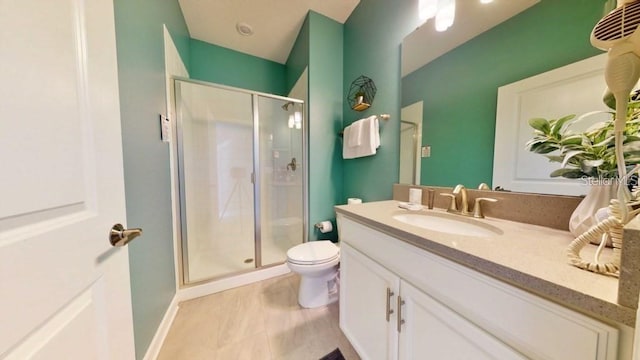 bathroom featuring tile floors, vanity with extensive cabinet space, toilet, and walk in shower