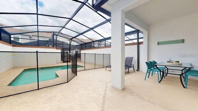 view of pool featuring glass enclosure and a patio