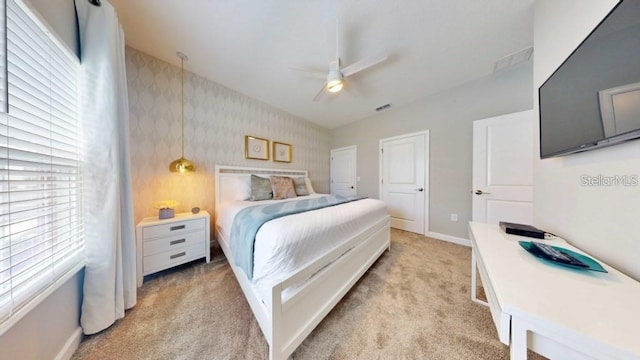 bedroom with light carpet and ceiling fan