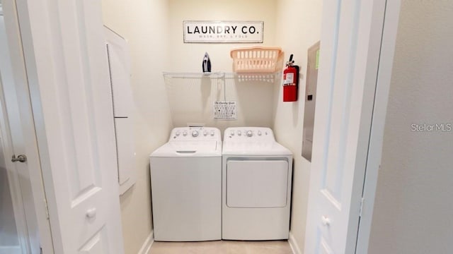 clothes washing area with washing machine and dryer