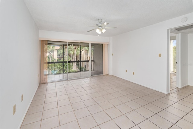 spare room with a wealth of natural light, ceiling fan, and a textured ceiling