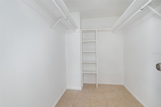 spacious closet featuring light tile patterned floors