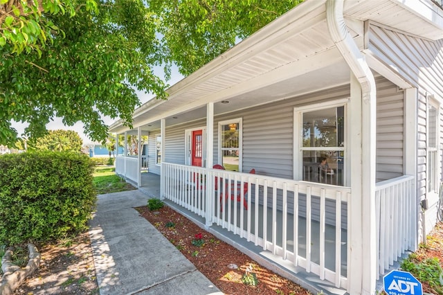 view of side of home with covered porch