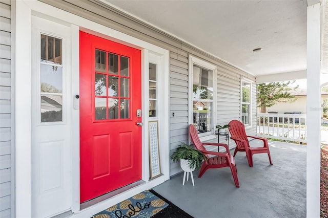 view of exterior entry with a porch