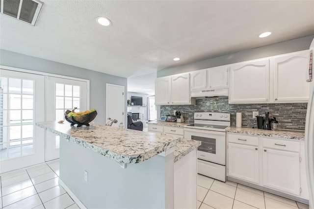 kitchen with a wealth of natural light, white electric range, and light tile floors