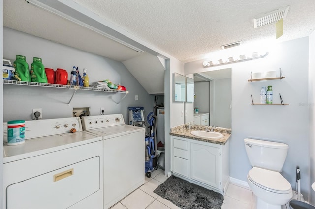 laundry area featuring hookup for an electric dryer, a textured ceiling, washer hookup, washing machine and clothes dryer, and light tile floors