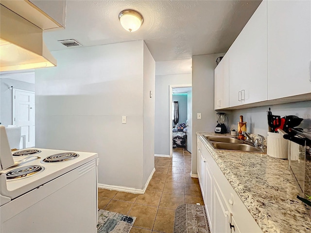 kitchen featuring light tile patterned floors, light countertops, white electric range, white cabinetry, and a sink