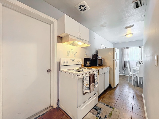 kitchen featuring white appliances, under cabinet range hood, and visible vents