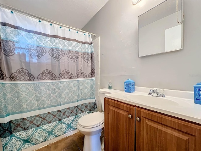 bathroom with toilet, curtained shower, vanity, and tile patterned floors