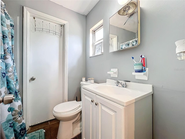 bathroom featuring vanity, toilet, and tile patterned floors