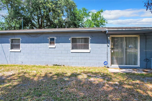 view of property exterior with concrete block siding