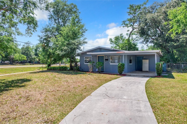 view of front of property featuring a carport, concrete driveway, a front yard, and fence