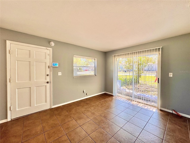 tiled empty room with baseboards