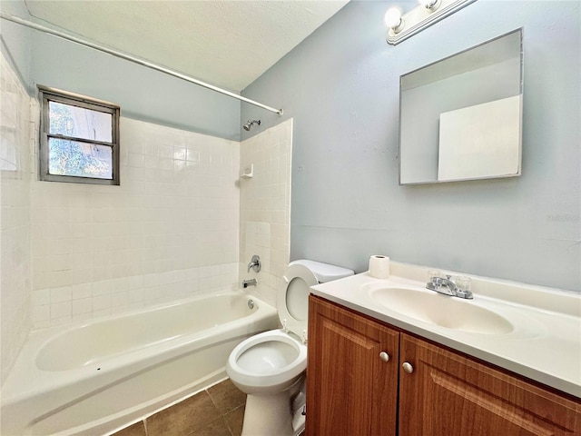 full bathroom featuring toilet, vanity, a textured ceiling,  shower combination, and tile patterned floors