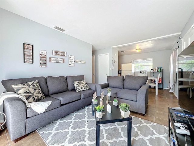 living area with tile patterned flooring and visible vents