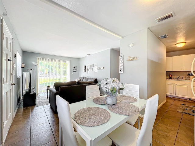 dining room with tile patterned flooring and visible vents