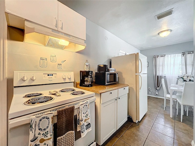 kitchen with under cabinet range hood, white appliances, visible vents, white cabinets, and light countertops