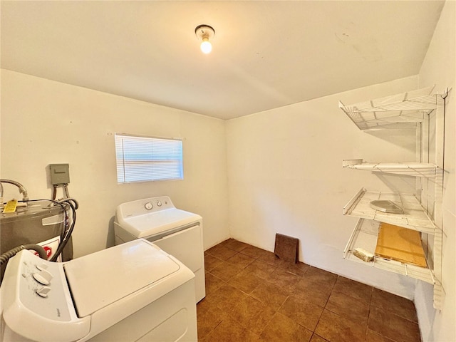 laundry area featuring laundry area, dark tile patterned flooring, and washer and clothes dryer