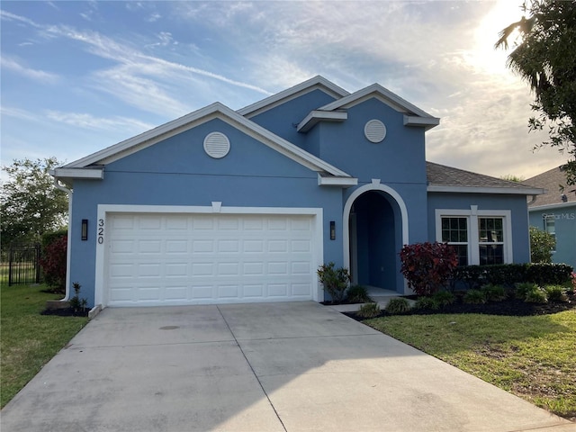 view of front property featuring a garage and a front lawn