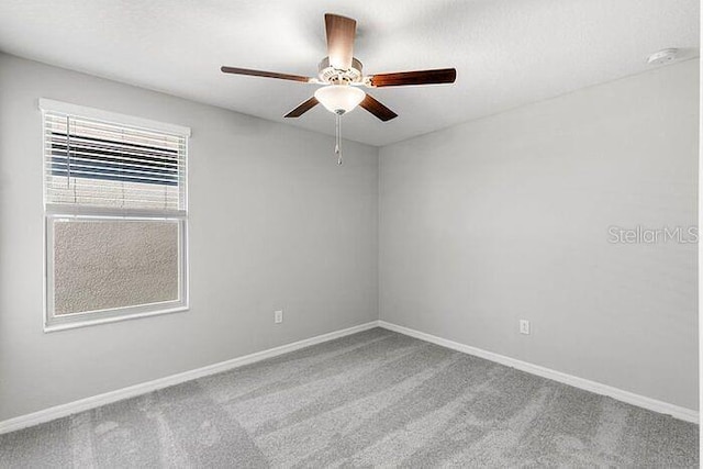 spare room with carpet floors and ceiling fan