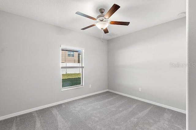 carpeted empty room featuring ceiling fan