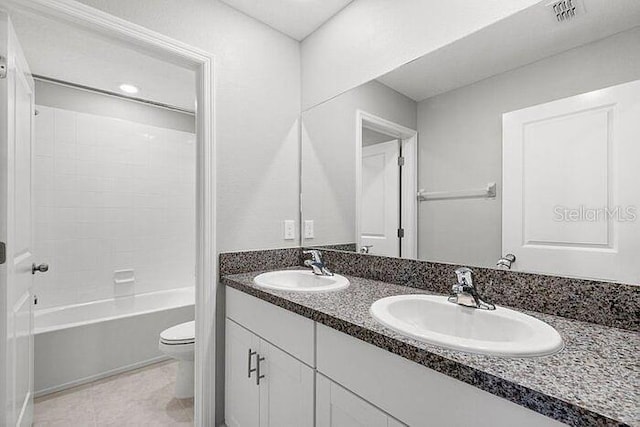 full bathroom featuring shower / bath combination, tile floors, dual bowl vanity, and toilet