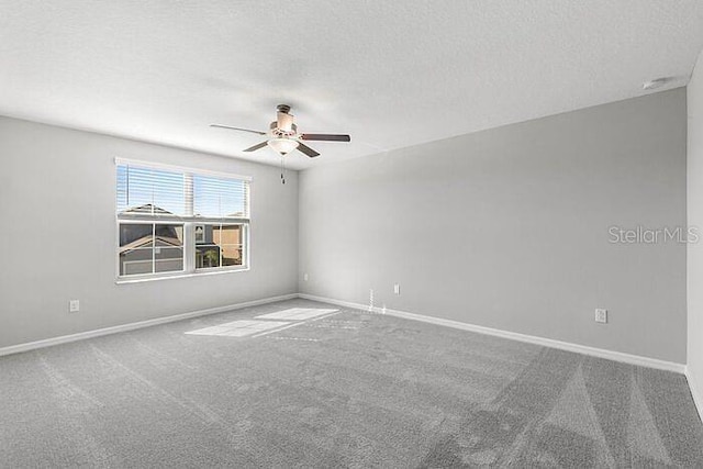 carpeted spare room featuring ceiling fan and a textured ceiling