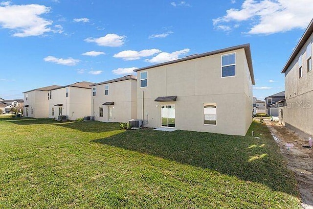 back of property featuring a yard and central AC unit