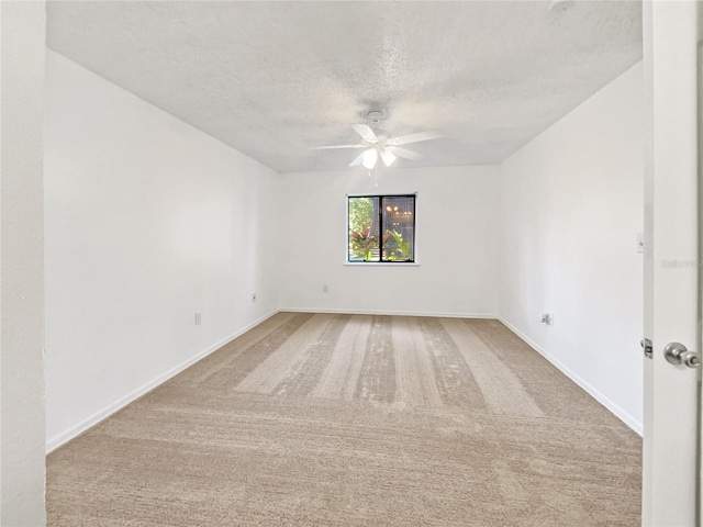 spare room with ceiling fan, carpet flooring, and a textured ceiling